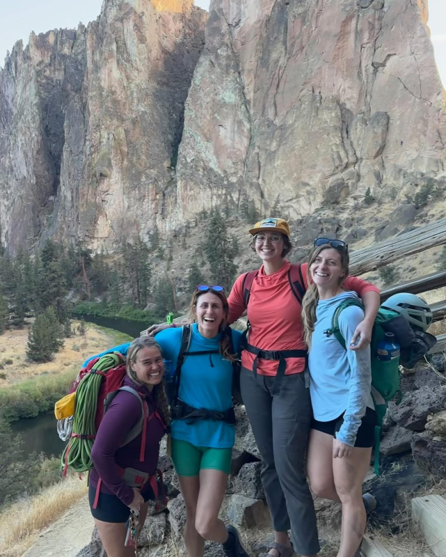 4 women rock climbers posed for a portrait at the crag.