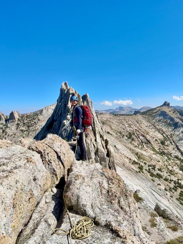 Woman rock climber on top of mountain.