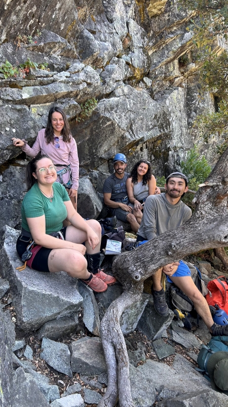 Rock climbers posed for portrait at outdoor crag.