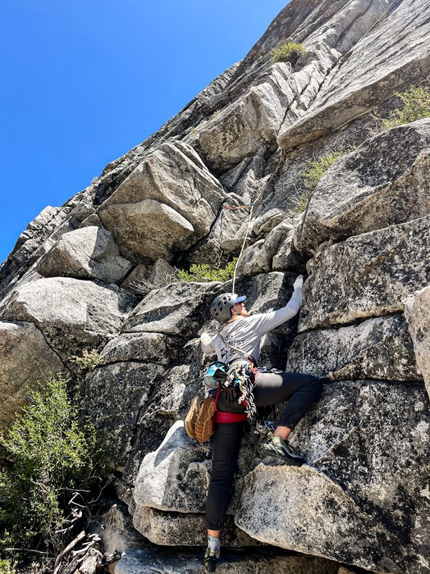 Woman rock climbing outside.