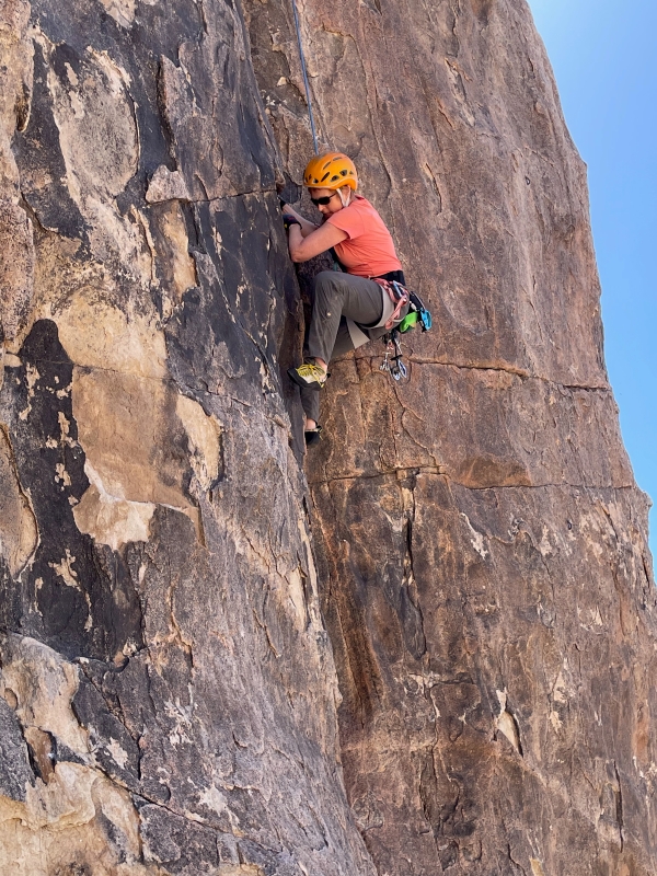 Woman rock climbing in Joshua Tree.