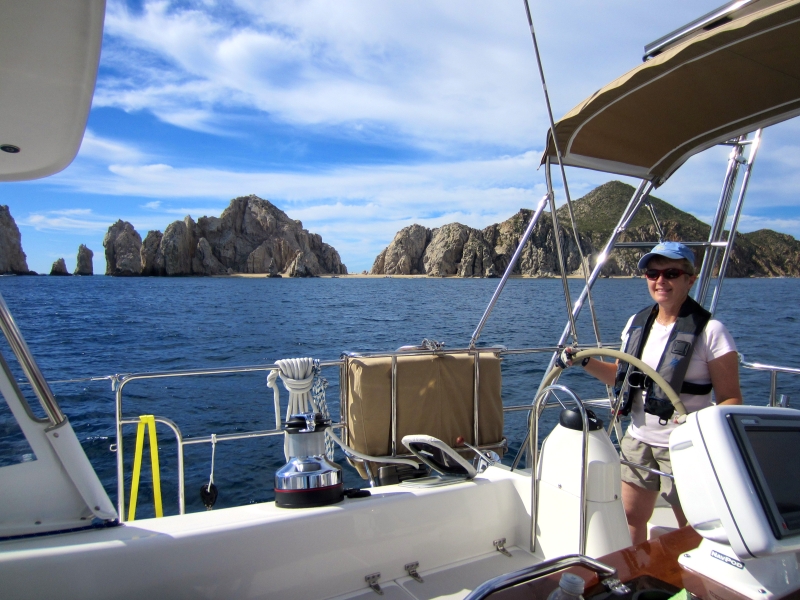 Woman sailing boat in Cabo San Lucas, Mexico.