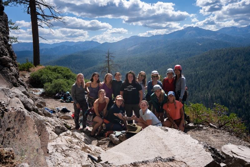 Group portrait of climbing friends at outdoor crag.