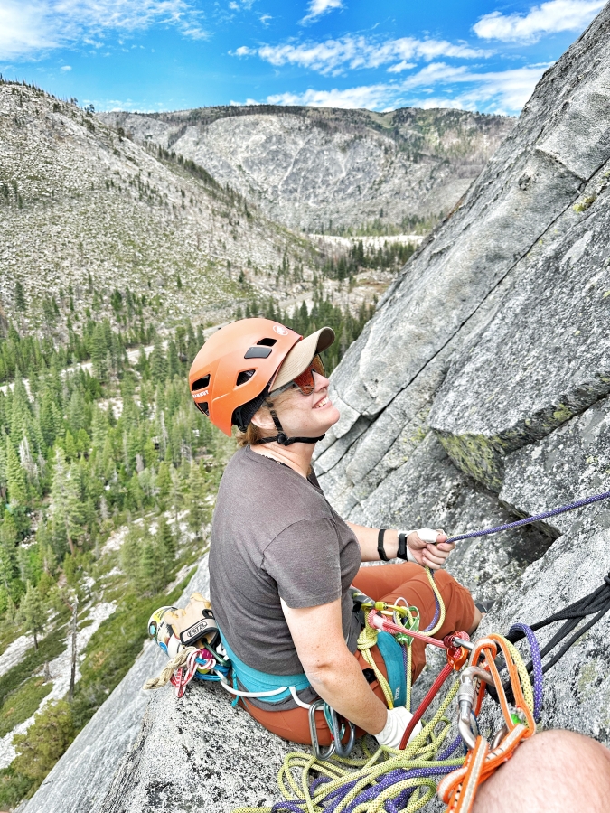 Woman rock climber belaying during multi-pitch climb at Lovers Leap.